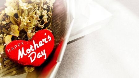 inspirational love concept - Happy mother's day text on red heart shaped in vintage backgroundの写真素材