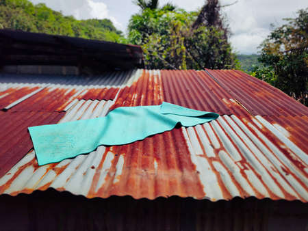 A yoga mat on top of rusty metal roof. Stock photo.の写真素材