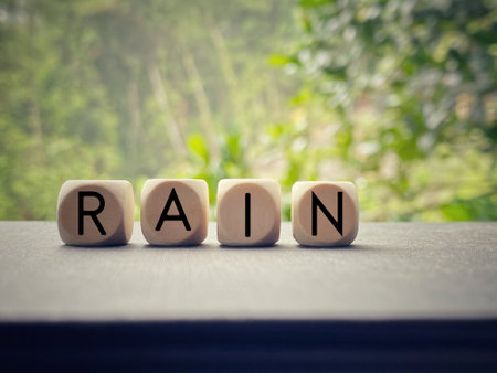 Word rain made with dice on a wooden tableの写真素材