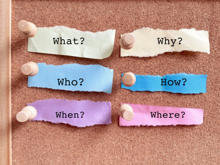 What's New Question written on sticky note pinned on cork boardの写真素材