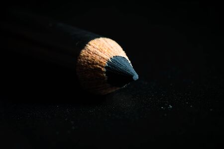 A macro shot of a black pencil tip. Kept in a dark backgroundの写真素材