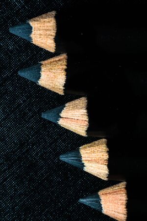A group of pencils are kept on a dark paper in ascending order. Education conceptの写真素材