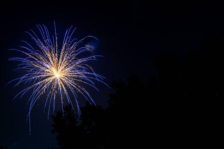 Blue fireworks at night skyの写真素材