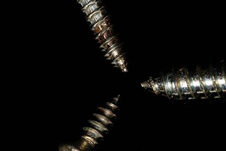 Tip of three screws in the center. Dark backgroundの写真素材
