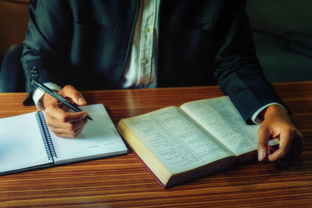 Men are writing books.の写真素材