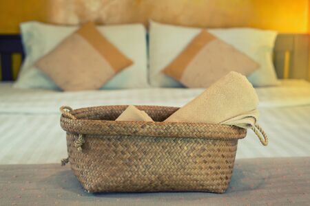 Bath towels in wicker basket on the bedの写真素材