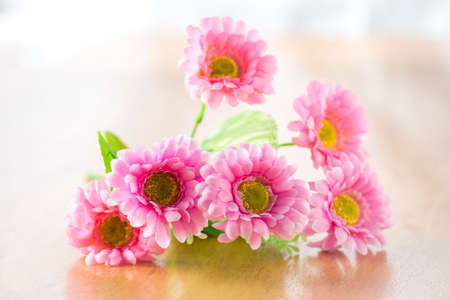 Bunch of artificial flowers on wood backgroundの写真素材