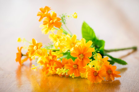 Bunch of artificial flowers on wood backgroundの写真素材