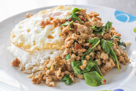 Thai spicy food, Spicy fried pork with basil and fried eggの写真素材