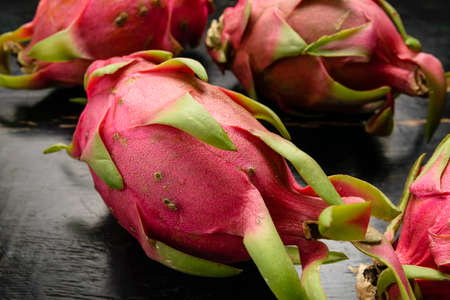 Dragon fruit on black wood backgroundの写真素材