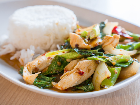 Fried kale and chicken with steamed rice.の写真素材