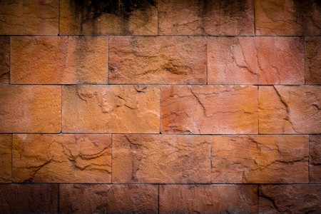 Old yellow stone wall backgroundの写真素材