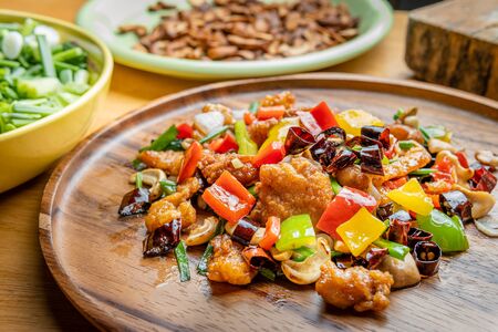 Stir fried Chicken with cashew nuts on wooden plateの写真素材