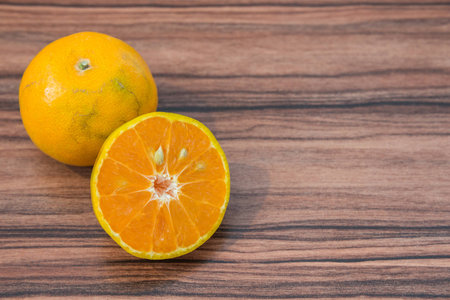 slice of fresh orange on wood table