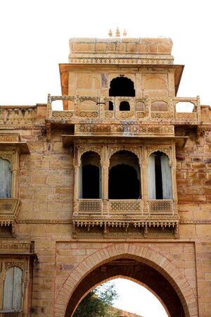 historical gateway building in yellow sandstone on lake shoreの写真素材