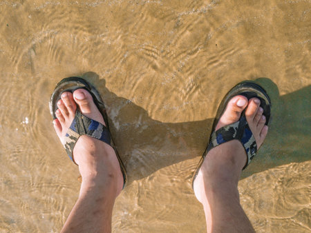 Upside down Asian people wear sandal on the Beach in vacation time,Summer concept