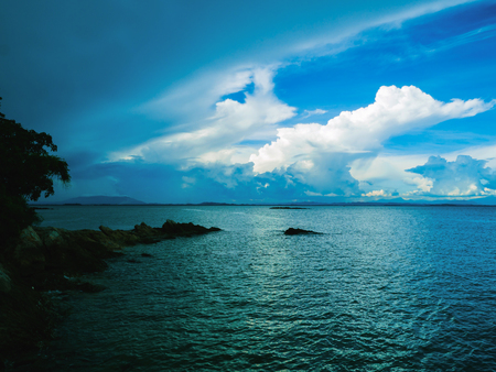 Rocky coast beach in the dark with idyllic ocean and beautiful sky,Summer conceptの写真素材