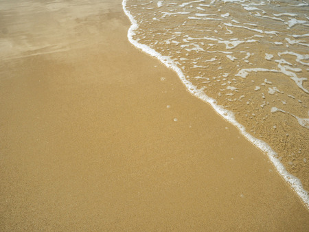 Beautiful sand on the beach with the ocean waves in vacation time,summer conceptの写真素材