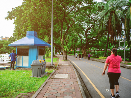 Asian runner women Jogging beside the lake in the city central park,running conceptの写真素材