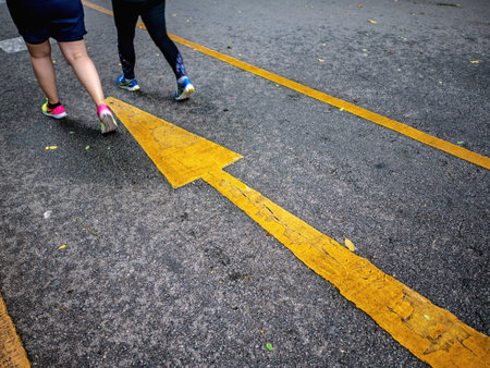 Yellow Forward sign and runner jogging on the road