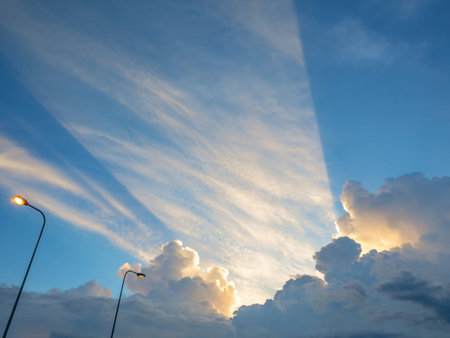 Idyllic blue sky with Sunset ray come out from the beautiful white cloud in the city,cloudscape...