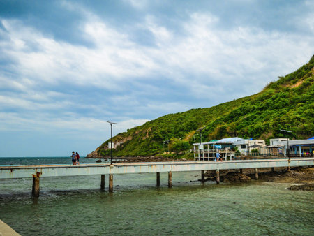 Concrete bridge Pier on the ocean with beautiful sky and mountain on vacation time,summer conceptの写真素材