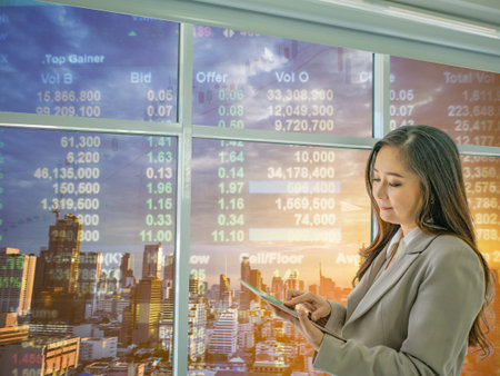 Modern business women Look at tablet thing about stock market,cityscape with stock number,business...