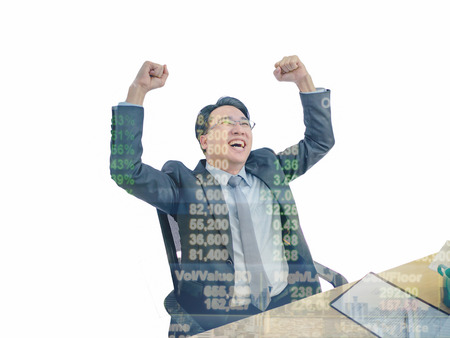 Happy asian business man sitting becuase his stock market growth up on his desk with isolated background,business concept
の写真素材