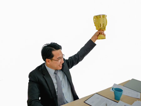 Asian Business man get the golden trophy on isolated background,business conceptの写真素材