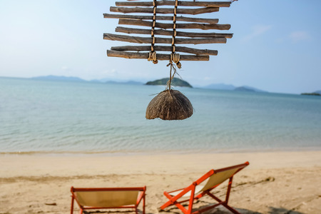 Close up coconut shell with idyllic ocean and beautiful sky in vacation,wooden chair relax on the beach,koh mak trat thailand,summer conceptの写真素材