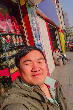 selfie Photo of Asian fat man traveler on the street in yiwu city chinaの写真素材