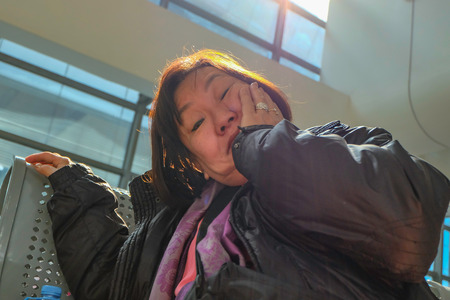 Old asian women traveler waiting for transit to shang hai in Yiwu High speed train terminalの写真素材