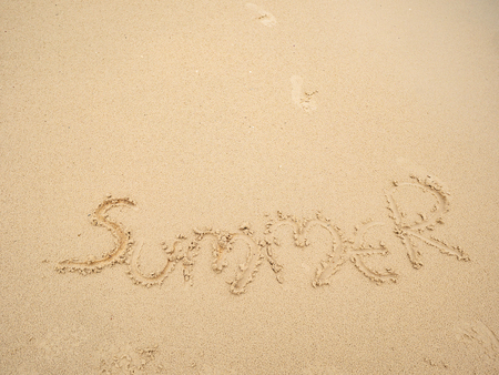 Summer text on the Sand floor in the beachの写真素材