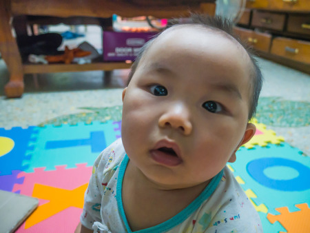 Cutie handsome asian baby on the baby foam for baby playgroundの写真素材