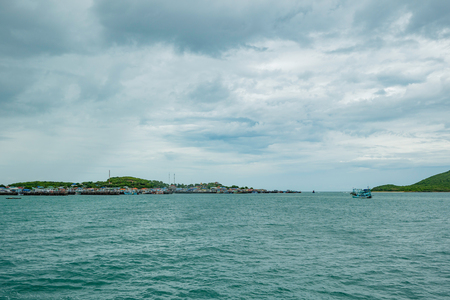Tropical idyllic ocean and blue sky with Raining on fisher town in the island. thailand travelの写真素材