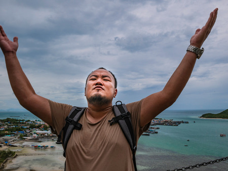 Asisn Fat Backpacker stand on top of  Khao Ma Jor Pier  with Idyllic ocean beautiful white cloud endless horizon and Fishman townscape in vacation time,chonburi thailand,holiday conceptの写真素材