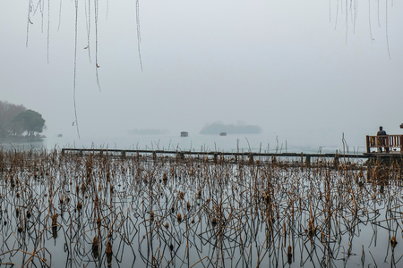 Beautiful Xihu lake(West Lake) with foggy or mist in winter season,hangzhou chinaの写真素材