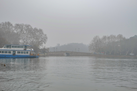 Beautiful Xihu lake(West Lake) one of destination in china with foggy or mist in winter seasonの写真素材