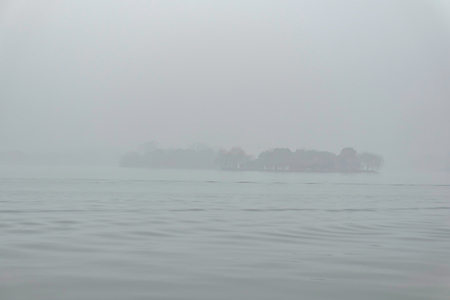 Beautiful Xihu lake(West Lake) with foggy or mist in winter seasonの写真素材