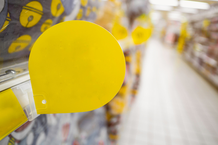 Mock up blank yellow discount tag on the products shelves in supermarketの写真素材