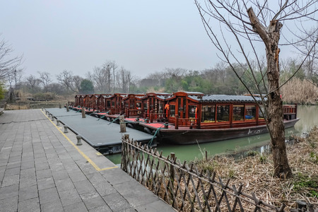 Ancient chinese style boat park on the boat dock in xixi national wetland park hangzhou city china in winter seasonのeditorial素材