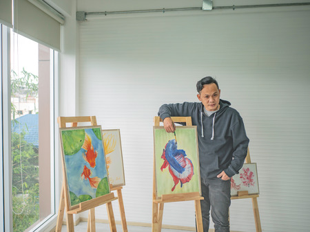Handsome Young Asian man or water color artist Teaching how to paint in studioの写真素材