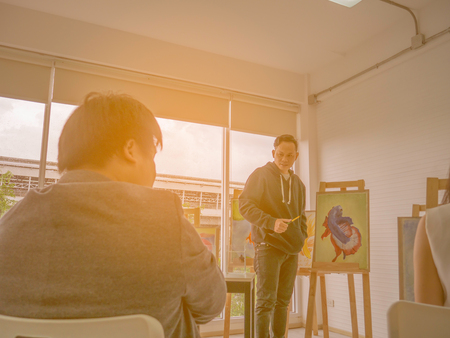 Handsome Young Asian man or water color artist Teaching how to paint in studio,fish conceptの写真素材