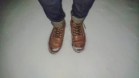 People wear Leather boots and stand on the snow in harbin city chinaの写真素材