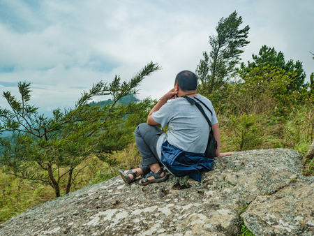 Asian Fat Trekker sit on the stone at Khao Luang mountain  in Ramkhamhaeng National Park,Sukhothai province Thailandの写真素材