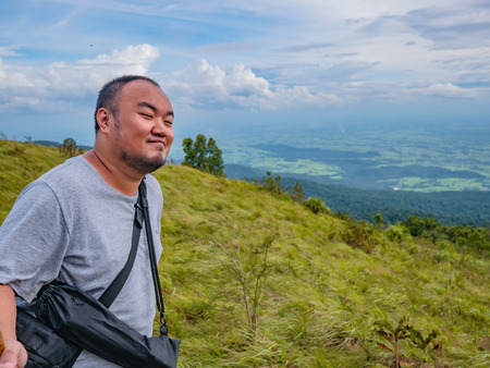 Asian Fat traveler trekking on Khao Luang mountain in Ramkhamhaeng National Park,Sukhothai province Thailandの写真素材