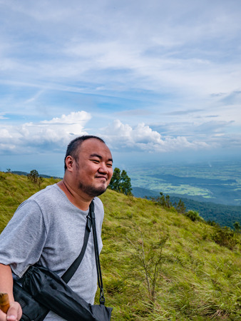 Asian Fat traveler trekking on Khao Luang mountain in Ramkhamhaeng National Park,Sukhothai province Thailandの写真素材