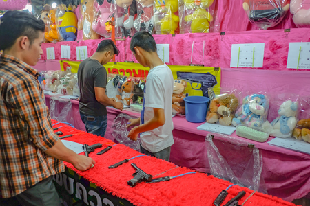 Bangkok/Thailand - 24 November 2015:Unacquainted Thailand people or tourist Playing thai Local Street Shooting Game  in"Loi Krathong" Temple Fair of Wat Saket Temple.Bangkok city Thailandのeditorial素材