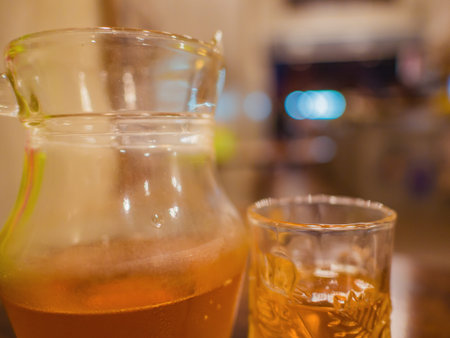 Harbal Tea in the Water pitcher and the Glass on the Wooden table in the cafe