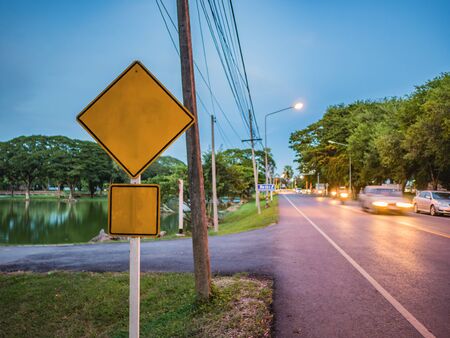 Mock up Yellow Traffic Sign Beside the Roadの写真素材